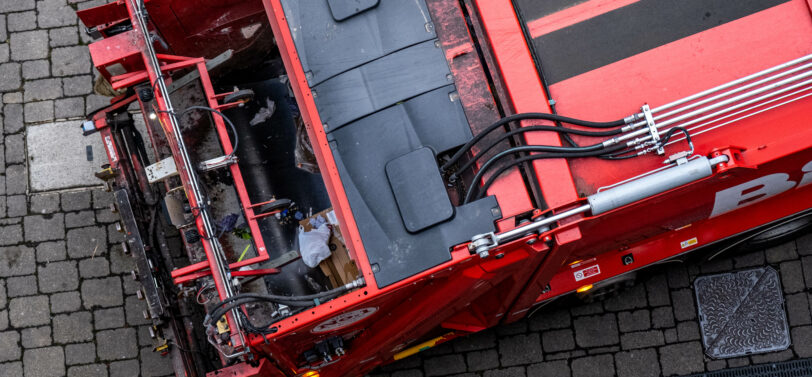 Red Refuse Truck Or Lorry Collecting Commercial Waste