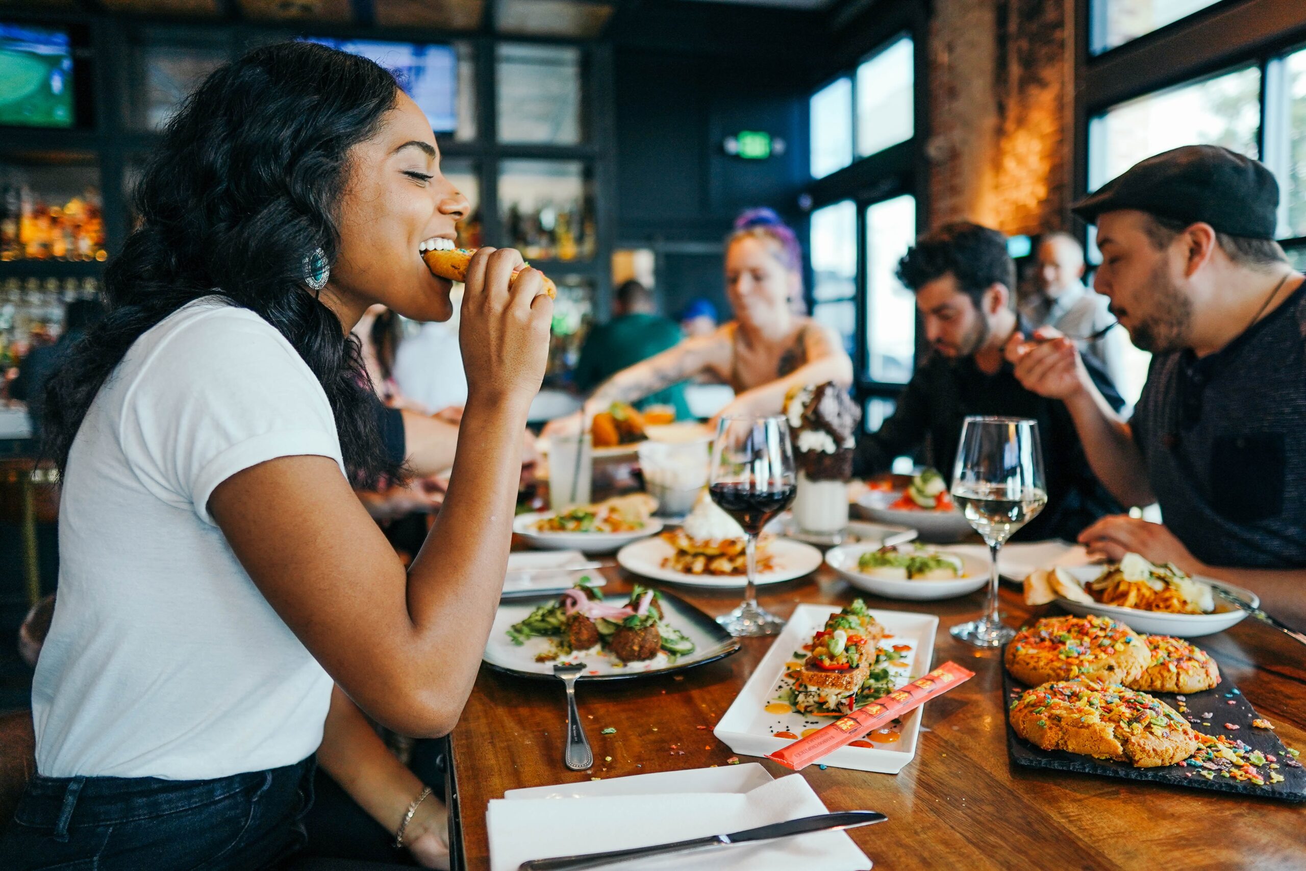 woman eating in restaurant with friends.