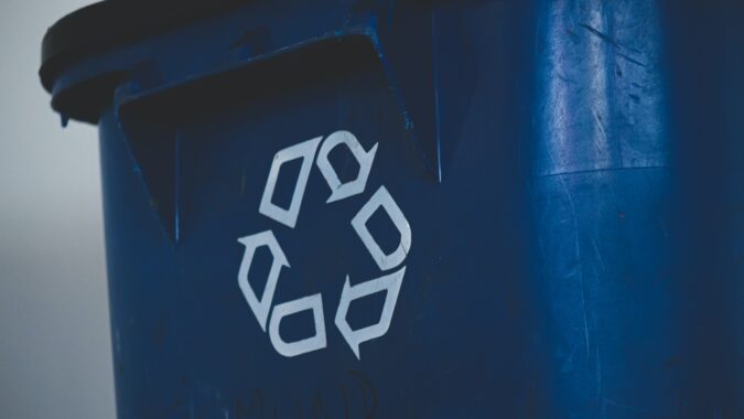 recycling logo on front of bin.