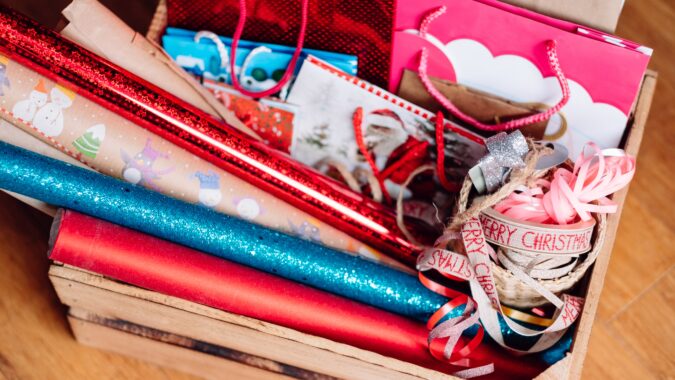 box of Christmas wrapping paper and gift bags.